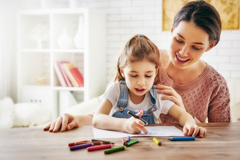 Parent and young child enjoying a simple learning activity together